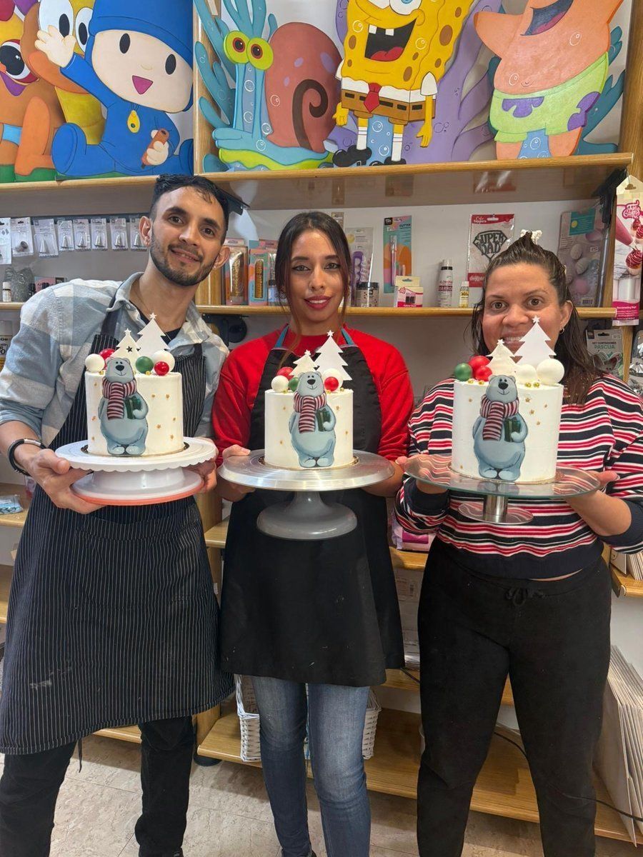 Alumnos felices con sus tartas terminadas junto a María
